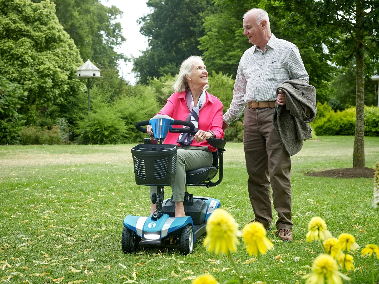 Showing Veo Sport Being driven through the park By a woman with a gentleman walking beside her smiling.