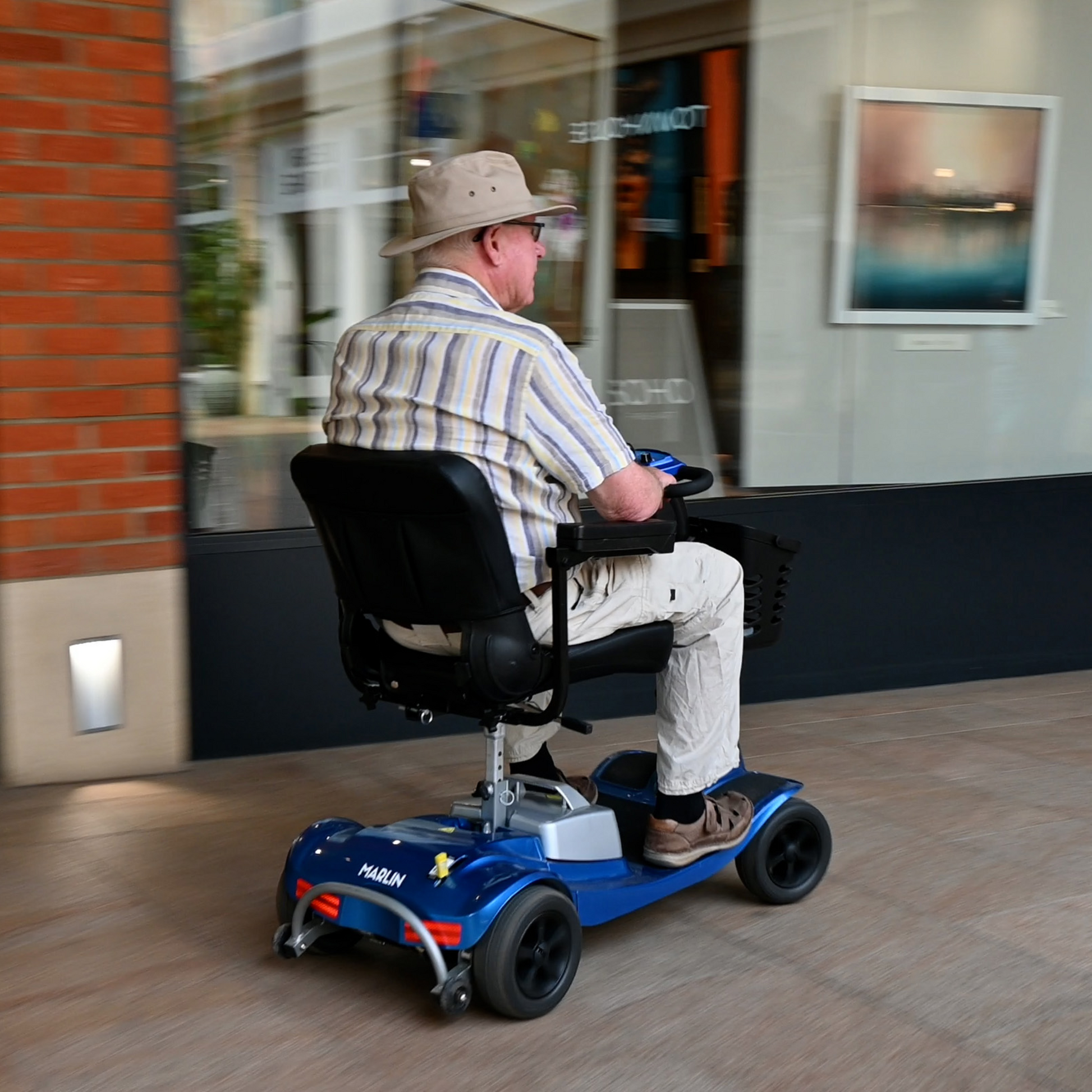 Showing Marlin Mobility Scooter Being driven through high street.