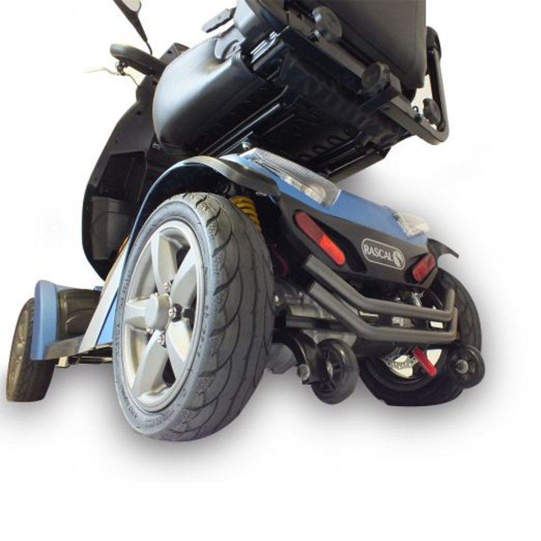 Showing the Vecta Sport Mobility Scooter from the underside, showing its large pneumatic tyres as well as the suspension. 